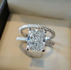 a cushion cut diamond ring in a box