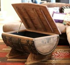 an open wooden box sitting on top of a table next to a couch and coffee table