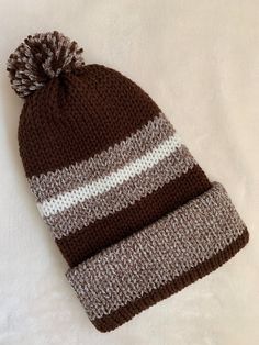 Adult unisex double layered beanie with matching Pom Pom. Made with soft acrylic yarn. Brown Cap For Cold Weather, Brown Knitted Casual Beanie, Brown Beanie Cap One Size Fits Most, Brown Acrylic Hats One Size Fits Most, Brown Knitted Beanie One Size Fits Most, Casual Brown Knitted Beanie, Brown Knitted Beanie Hat, Brown Knitted Hats For Cold Weather, Brown Knit Crochet Hat For Cold Weather