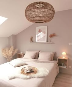 a bedroom with a wicker basket hanging from the ceiling and bed in front of it