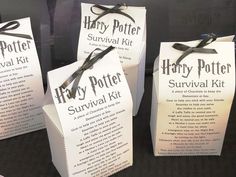 three harry potter survival kit bags with ribbons tied around the front and back, sitting on a table