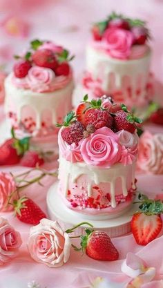 three tiered cake with pink flowers and strawberries on the top, surrounded by roses