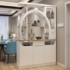 a modern dining room with white cabinets and blue chairs