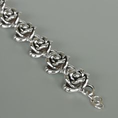 This is a beautiful sterling silver bracelet made with 8 rose links. Length: 7 inches Rose: 19 x 19mm Weight: 21.2gm This bracelet is made of 925 hypoallergenic sterling silver by the Electroform method. This piece is sent in a gift box. I can include a personal message from you if needed You are welcome to contact me at... bhavnakwintra1956@gmail.com For more beautiful pieces from my shop, please browse 👇 TOE RINGS: https://www.etsy.com/your/shops/TheSilverGame/tools/listings/section:27020628, Luxury Silver Jewelry With Rose Design, Affordable Sterling Silver Bracelet For Valentine's Day, Bracelets Silver Rose, Wrist Chain, Bracelet Wrist, Sterling Silver Bead Bracelet, Wrist Jewelry, Rose Bracelet, 925 Silver Bracelet