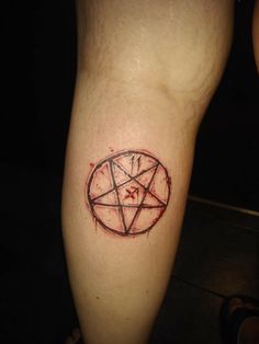 a person with a pentagramil tattoo on their leg