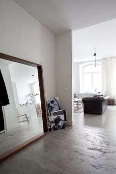 a large mirror sitting in the middle of a living room