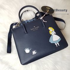 Name - Disney X Kate Spade New York Alice In Wonderland Shopper Crossbody Bag Blue `` Price Is Firm `` More Details - 7'' H X 8.4''W X 3.1''D Handle Drop: 3.54'' Strap Drop: 22" Textured Pvc Metal Pinmount Logo Cotton Twill Lining Interior Back Zip Pocket Drawstring Closure Dust Bag Not Included + Bag Is Authentic ++ From Smoke Free & Pet Free Home +++ No Trades ++++ Check Out My Other Listings I Have Available From Avantbeautybags Photos Are Taken With Bright Lighting And Colors May Vary Under Kate Spade Disney Everyday Bag, Kate Spade Disney Style Everyday Bags, Disney Blue Shoulder Bag For Travel, Alice In Wonderland Bag, Mens Monogram, Kate Spade Disney, Monogram Backpack, Bright Lighting, Leather Satchel Handbags