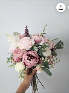 a person holding a bouquet of flowers in their hand