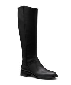 Meet our first-ever tall boot—an elegant reimagining of our best-selling smoking slipper for winter’s colder months. Crafted from premium black leather with a faux stretch leather back, it offers a sleek fit that stretches comfortably to fit most, including wider, calf sizes with ease. This equestrian-inspired riding boot features a stunning tuxedo grosgrain back tab spine that molds to your leg, and the slightly curved topline offers a slimming effect. The footbed includes our signature 7 layer Classic Tall Winter Boots, Classic Tall Black Boots, Classic Tall Boots, Classic Leather Sole Knee-high Boots For Winter, Classic Knee-high Boots With Leather Sole For Winter, Classic Winter Knee-high Boots With Leather Sole, Black Flat Boots, 7 Layer, Black Boots Tall