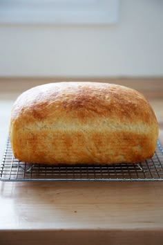 a loaf of bread sitting on top of a cooling rack