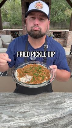 a man holding a plate with food on it and the caption reads, fried pickle dip