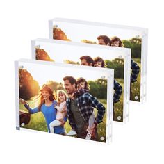 three clear acrylic photo frames with an image of people