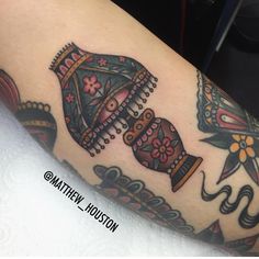 a woman's arm with tattoos on it