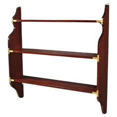 a wooden shelf with three shelves and brass trimmings on the bottom, against a white background