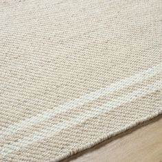 a white rug on top of a wooden floor