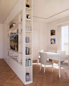 a dining room with white furniture and wooden floors