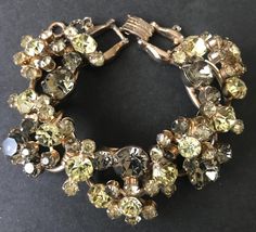 Vintage Juliana Rhinestone Bracelet ** 1960's D & E Delizza and Elster 5 link Collectible Jewelry ** Designer Jewelry I love this bracelet and its design. 5 Link Juliana designer bracelet Has a great look & feel to it. Has a nice weight to it also. It is in very good vintage condition. Measures 7 1/2 inches long by 1 inch wide. The colors on this are just stunning, I really like it a lot. I cannot figure out how to describe the colors on it though, my best attempt is either greens or gray and yellows. Either way just beautiful.  It is very sparkly and pretty. I honestly think it is soooo much prettier in person than what my photos depicted.  Don't miss out on this beautiful Juliana bracelet.... Simply stunning.... Thanks for stopping by Hope you are able to come back often... I have much m Designer Bracelet, Bracelets Design, Bracelet Vintage, Rhinestone Bracelet, Jewelry Designer, Designer Jewelry, Bracelet Designs, Link Bracelets, Arm Band