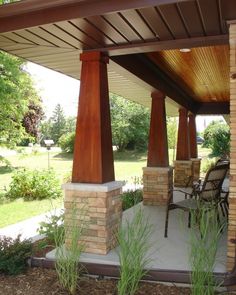 an outdoor covered patio with chairs and tables