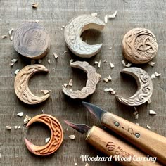 several different types of wood carving tools on top of a wooden table with seeds scattered around them