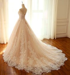 a wedding dress on display in front of a window