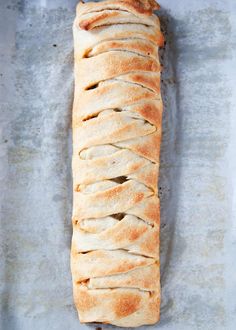 a long loaf of bread sitting on top of a pan