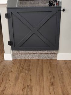 a black and white stove top oven sitting on top of a hard wood floor next to a wall