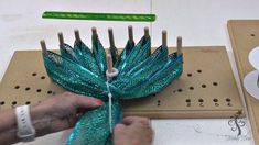 a person is working on something that looks like a leaf