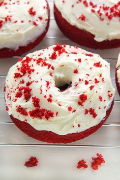 red velvet cupcakes with white frosting and sprinkles