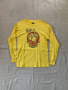 Vintage long sleeve tee with funny graphic and quote, in overall good condition with some faint staining on left sleeve. Fits like a modern Medium Pit to pit 19" Length 26" PLEASE READ! *MEASUREMENTS* All items are measured while laying flat and unstretched. For clothing: chest, waist, hip and thigh measurements should be multiplied by two. All measurements are in inches. *VINTAGE CONDITION* Vintage goods may show signs of wear and age. We always indicate and/or show in pictures any major flaws or blemishes, but will not always mention small flaws, such as pinpoint sized spots or holes. If you are concerned about a particular item's condition, please message us. All of our pieces are pre-owned. We use a natural detergent to wash all our textiles when necessary (with a few exceptions such a Natural Detergent, Funny Graphics, Funny Quote, 1980s Vintage, Vintage Tees, Long Sleeve Tee, Vintage 70s, Made In Usa, Long Sleeve Tees