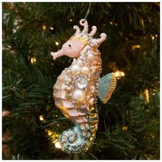 a sea horse ornament hanging from a christmas tree