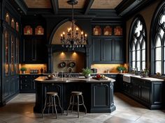 a large kitchen with black cabinets and chandelier hanging from the ceiling, along with two bar stools