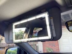 an image of a car mirror that is in the back of a vehicle with it's lights on