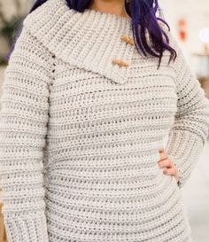 a woman with purple hair wearing a white sweater