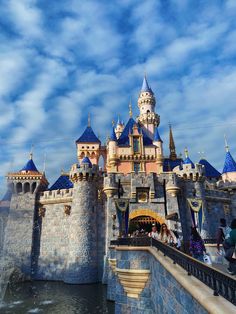 people are standing on the side of a castle