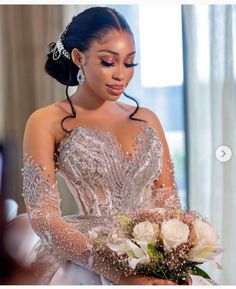 a woman in a wedding dress holding a bouquet