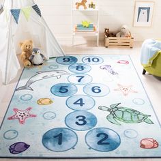 a child's rug with numbers and sea animals on it in a nursery room