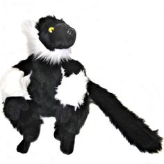 a black and white stuffed animal with yellow eyes