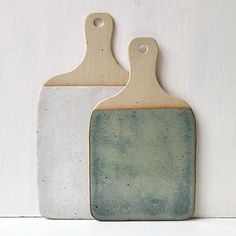 two ceramic cutting boards sitting side by side