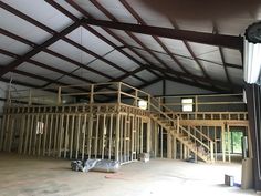 the inside of a building being built with wood framing and metal roof trussing on the second floor