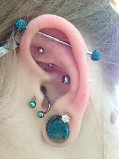 an ear with several piercings attached to it