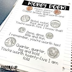 an open notebook with writing on it and some coins in the pages next to it