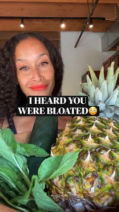 a woman holding up a large pineapple next to another pineapple and the words i heard you were bloated