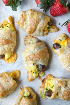 several pastries with different toppings and strawberries