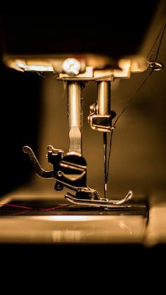 the sewing machine is close up in the dark