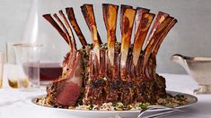 a large piece of meat sitting on top of a plate next to utensils