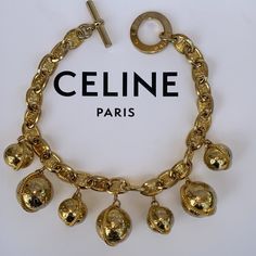 This Is A Gorgeous Celine Charm Necklace With 7 Ball Star Large Charms, 100% Authentic And Vintage, In Very Good Condition Much Nicer Than Pics Depict Due To Lighting And Shadows (!) Very Shiny, (Go?) Showing Only The Slightest Signs Of Use. Please Review Photos Closely And Ask Questions Before Purchasing Or Sending An Offer These Vintage Pieces Are Very Coveted And Hard To Find Especially In This Condition. Chain Length Including Toggle Closure Measure’s 17”, Ball Charms Large Approximately 2” And Small Charms, Approximately 1” Or Circumference 3.6” And 2.6”. Feel Free To Ask Questions. Top Rated Trusted Seller And Suggested User Selling Authentic Luxury Items On Posh Since Celine Jewelry, Celine Necklace, Small Charms, Vintage Pieces, Arm Candy, Light And Shadow, Luxury Items, Top Rated, Chain Lengths