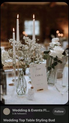 the table is set with flowers and candles for a wedding or special event in glass vases