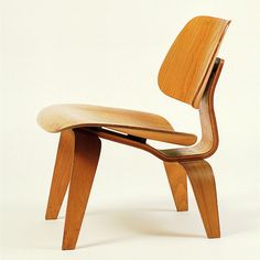 a wooden chair that is sitting up against a white background with no one around it