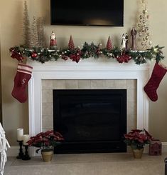 a living room decorated for christmas with stockings on the mantel