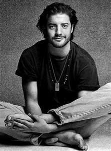 a black and white photo of a man sitting on the floor